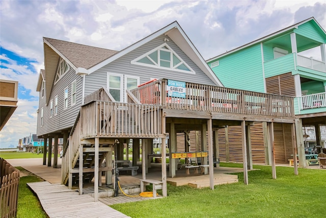 103 Southwind Dr, Surfside Beach, TX 77541 - back of house with a deck, stairs, a yard, a shingled roof, and a patio