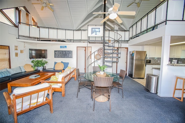 103 Southwind Dr, Surfside Beach, TX 77541 - carpeted dining room featuring ceiling fan, high vaulted ceiling, beamed ceiling, and stairs