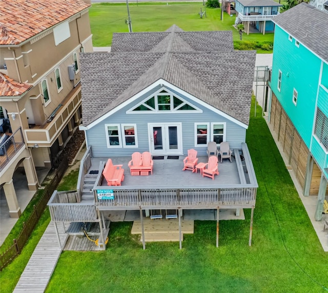 rear view of property with a yard and a wooden deck