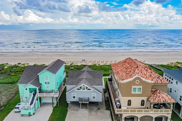 birds eye view of property featuring a view of the beach and a water view