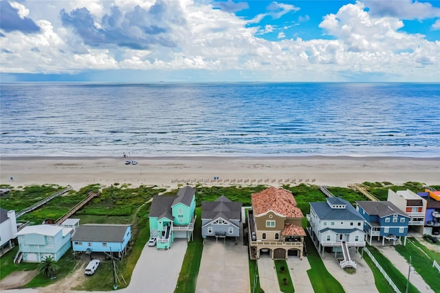 birds eye view of property featuring a beach view and a water view