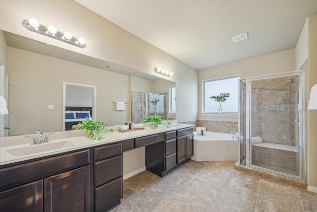 bathroom with vanity and separate shower and tub