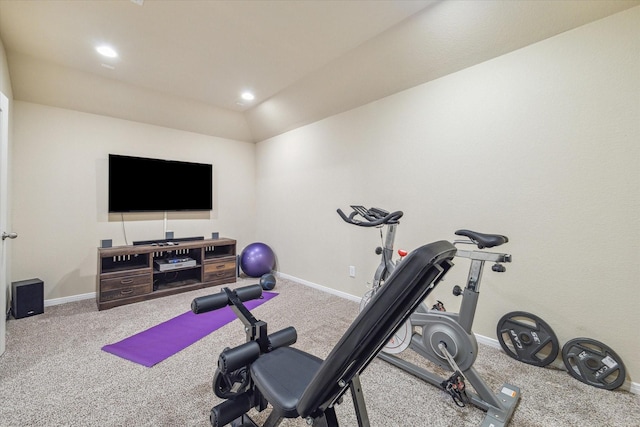 workout area featuring carpet flooring and lofted ceiling