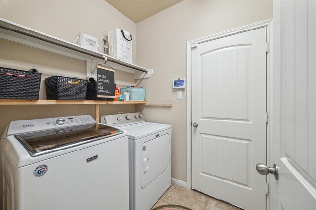 clothes washing area featuring independent washer and dryer