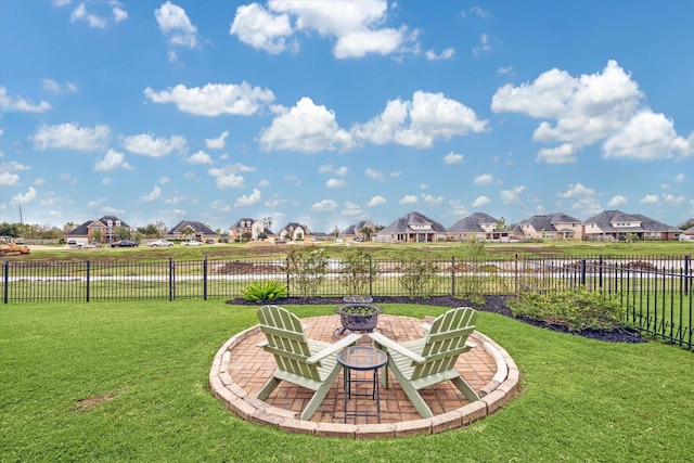 view of yard with a water view, a fire pit, and a patio area