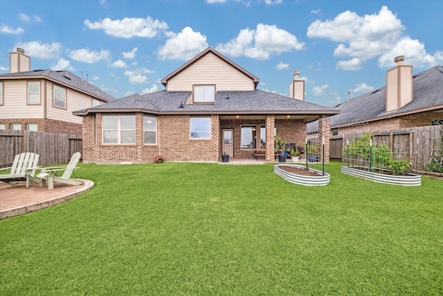 rear view of property with a patio area and a yard