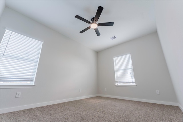 carpeted empty room with plenty of natural light and ceiling fan