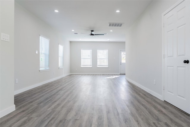 unfurnished living room with wood-type flooring and ceiling fan