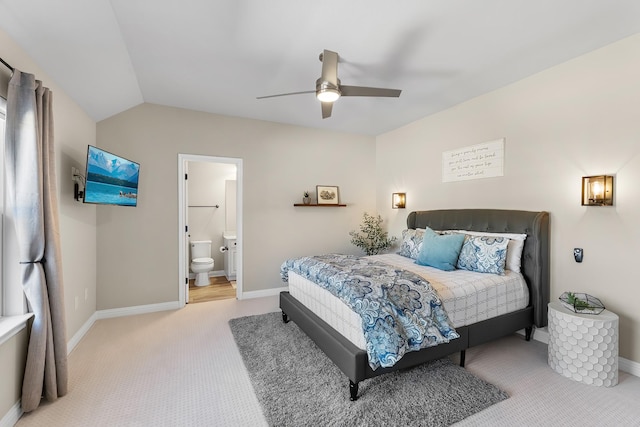 carpeted bedroom featuring ceiling fan, connected bathroom, and vaulted ceiling