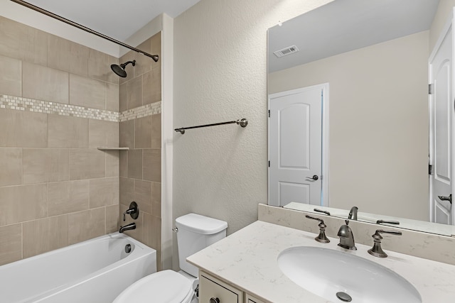 full bathroom with vanity, toilet, and tiled shower / bath combo