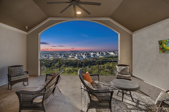 patio terrace at dusk with outdoor lounge area and ceiling fan