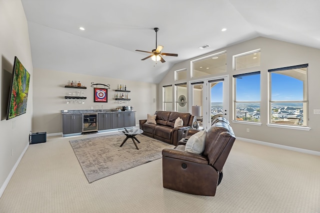 carpeted living room with wine cooler, lofted ceiling, ceiling fan, and bar area