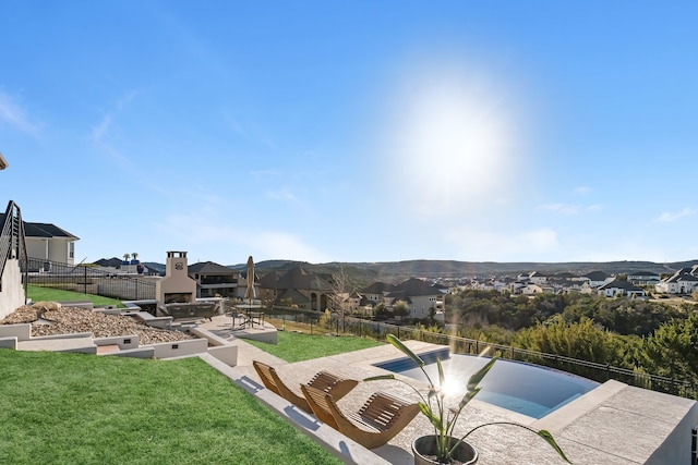 exterior space featuring a mountain view, exterior fireplace, and a patio area