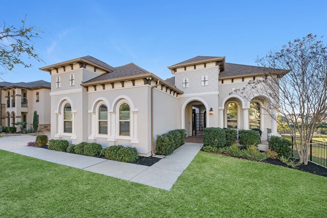 mediterranean / spanish-style home with a front yard