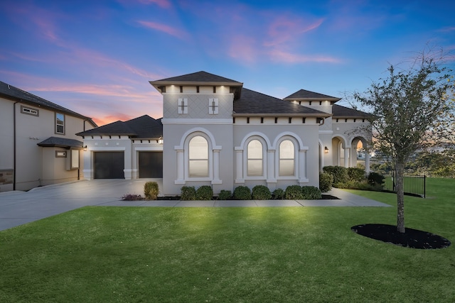 mediterranean / spanish-style home with a garage and a lawn