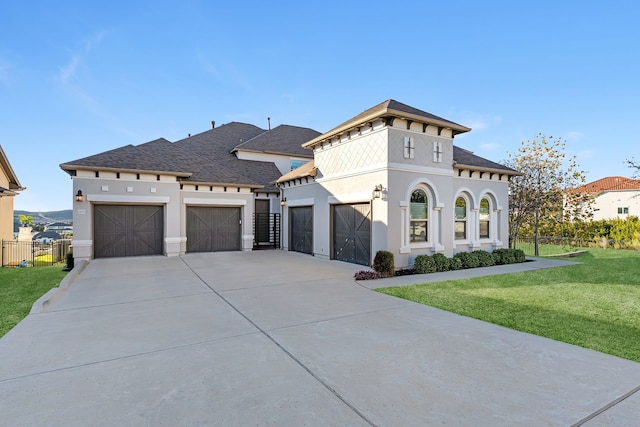 view of front of property featuring a garage and a front yard