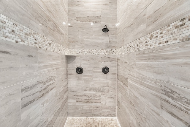 bathroom with a tile shower