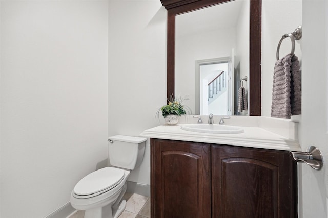 bathroom with tile patterned floors, vanity, and toilet