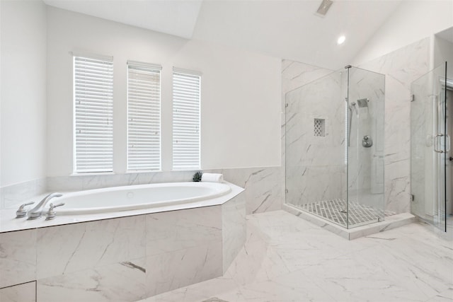 bathroom featuring independent shower and bath and lofted ceiling