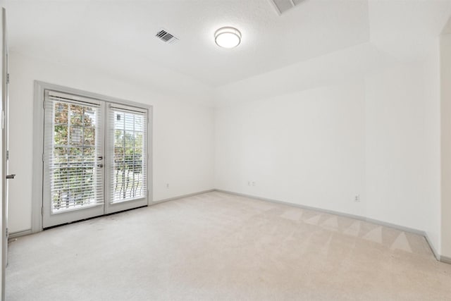 unfurnished room featuring light carpet