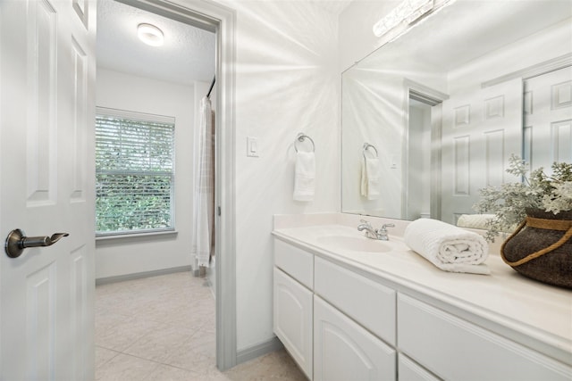 bathroom with tile patterned floors, vanity, a textured ceiling, and a shower with shower curtain