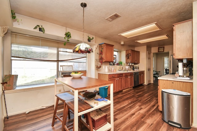 kitchen featuring dishwashing machine, dark hardwood / wood-style flooring, pendant lighting, and sink