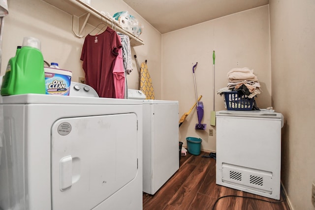 laundry room featuring washer and clothes dryer and dark wood-type flooring