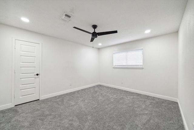 spare room featuring carpet and ceiling fan