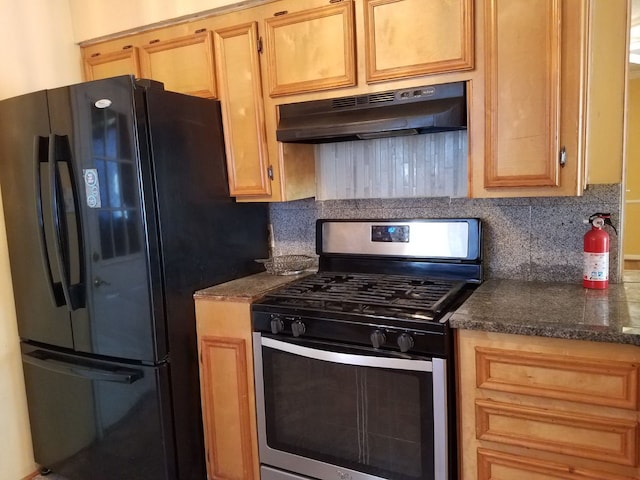 kitchen featuring tasteful backsplash, light brown cabinetry, black refrigerator, and stainless steel range with gas stovetop