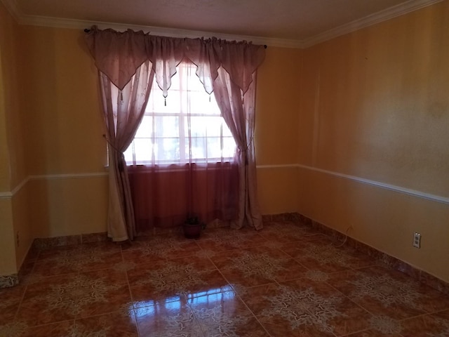 unfurnished room featuring crown molding