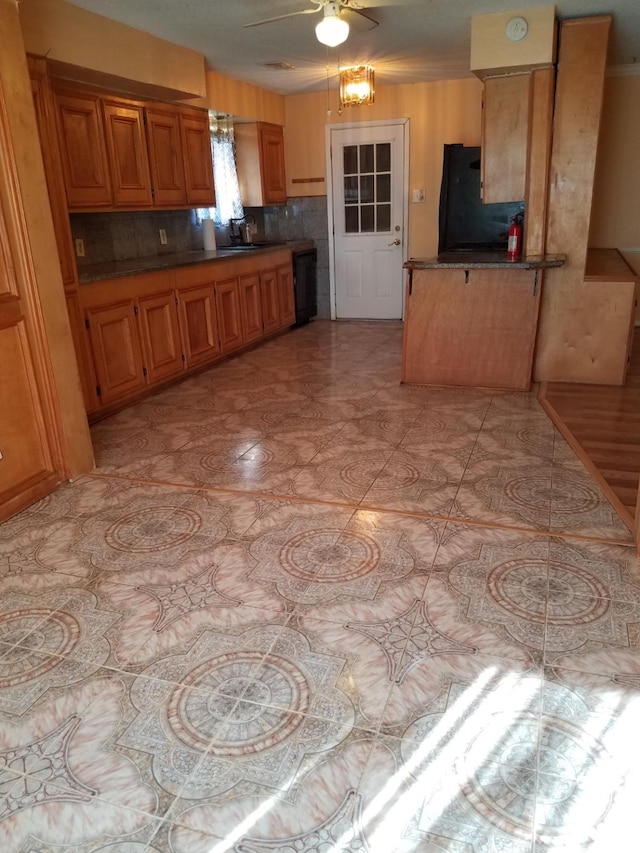 kitchen with dishwasher, backsplash, sink, ceiling fan, and fridge