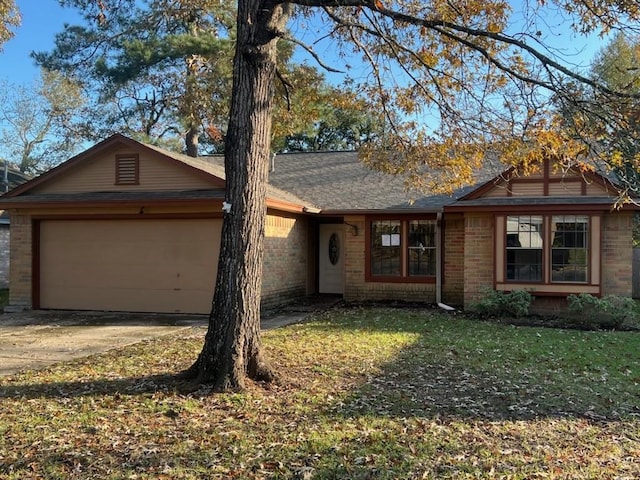 ranch-style home with a front yard and a garage