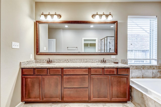 bathroom featuring shower with separate bathtub and vanity