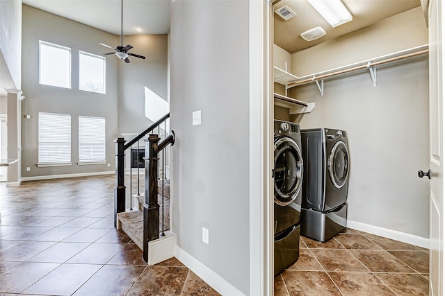 washroom featuring tile patterned flooring, ceiling fan, a healthy amount of sunlight, and washing machine and clothes dryer