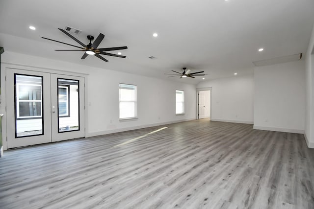 spare room with ceiling fan, french doors, and light wood-type flooring