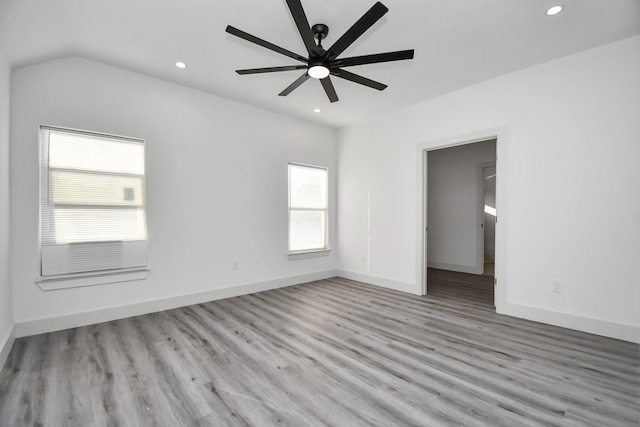 spare room with ceiling fan, a healthy amount of sunlight, and light hardwood / wood-style flooring