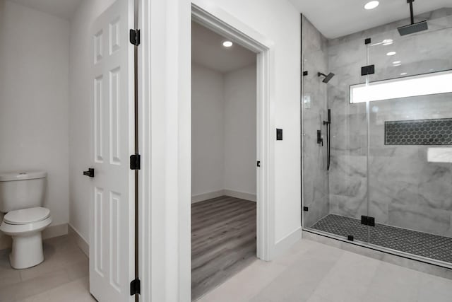 bathroom featuring toilet and an enclosed shower