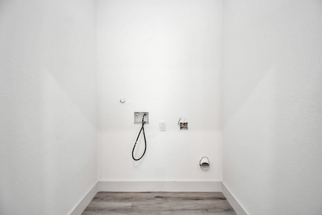 laundry room featuring hookup for an electric dryer, hookup for a washing machine, and light hardwood / wood-style floors