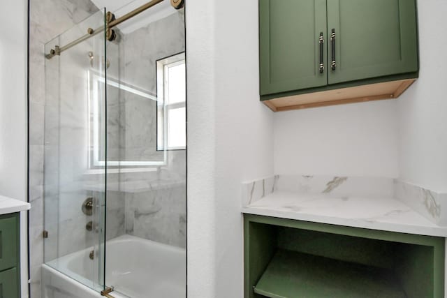 bathroom with vanity and bath / shower combo with glass door