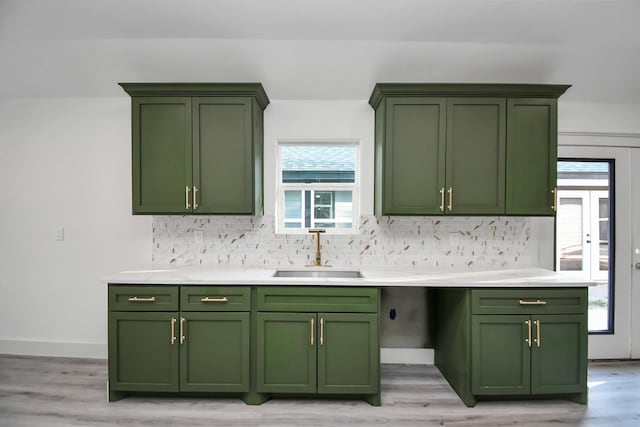 kitchen featuring green cabinets and sink