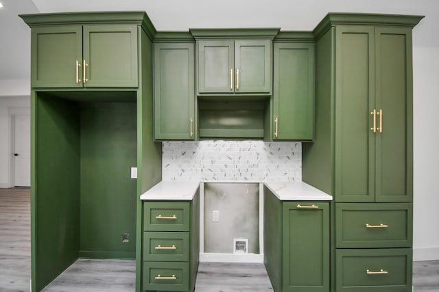 kitchen featuring green cabinets, decorative backsplash, and light hardwood / wood-style floors