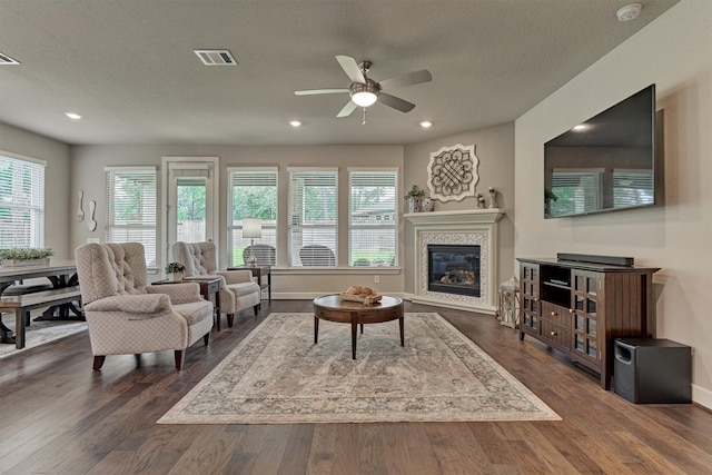 living room with dark hardwood / wood-style floors and ceiling fan