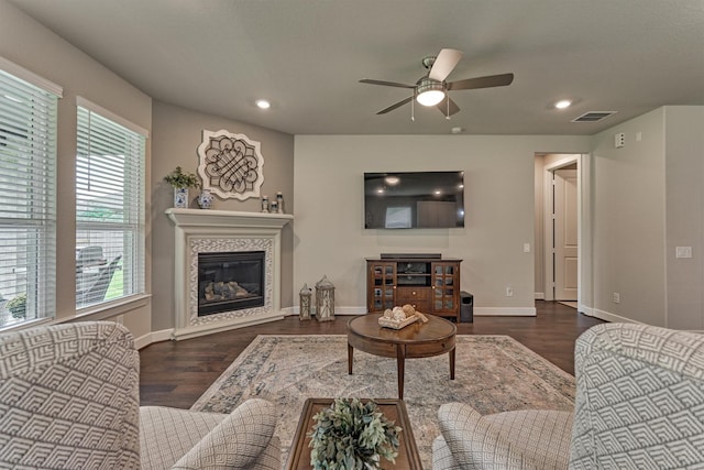 living room featuring ceiling fan and dark wood-type flooring