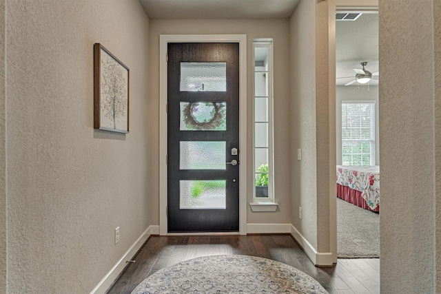 entrance foyer featuring ceiling fan and dark wood-type flooring