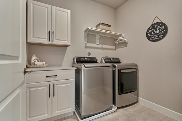 washroom featuring washer and dryer and cabinets