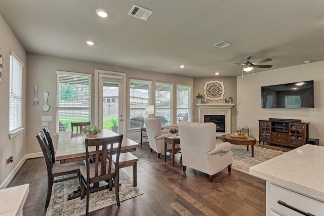 living room featuring plenty of natural light, ceiling fan, and dark hardwood / wood-style floors