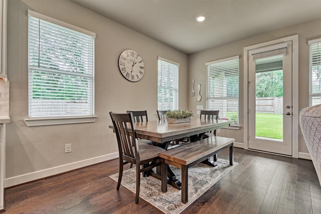 dining space with dark hardwood / wood-style flooring