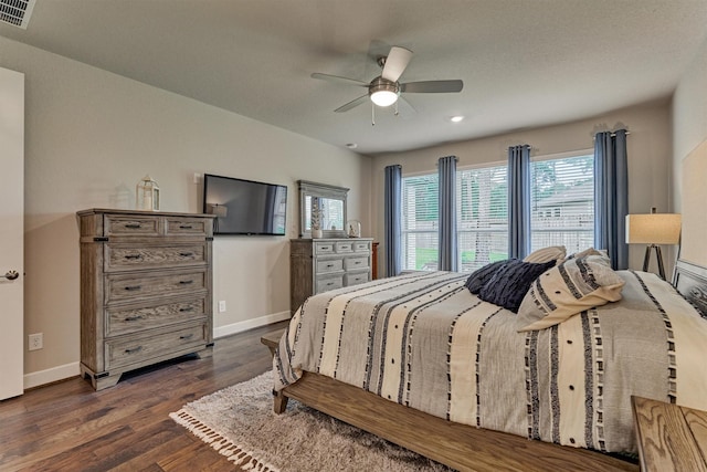 bedroom featuring ceiling fan and dark hardwood / wood-style floors