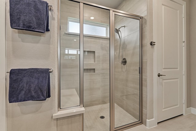 bathroom with tile patterned floors and walk in shower