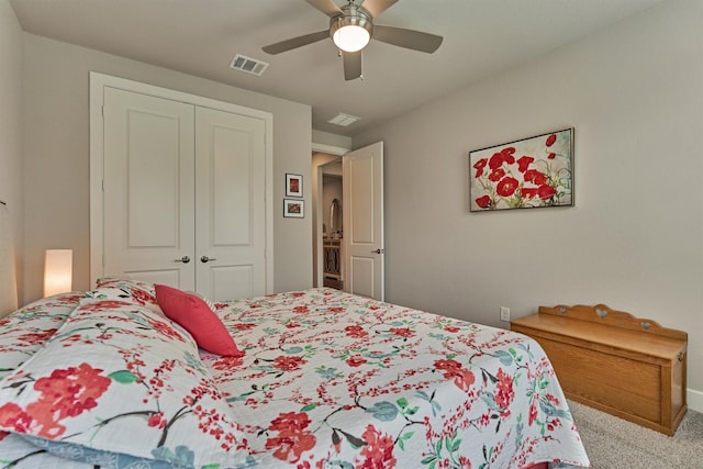 bedroom with ceiling fan, light colored carpet, and a closet